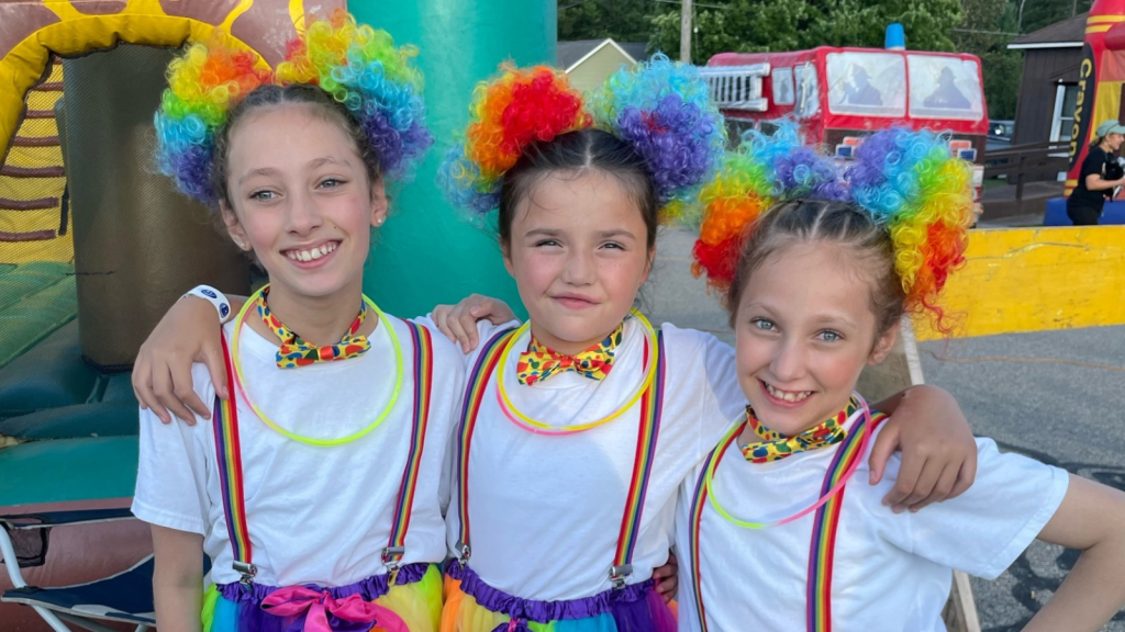 Three young girls dressed as clowns for the 2023 Troutarama Junior Parade